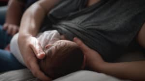 mama breastfeeding newborn baby