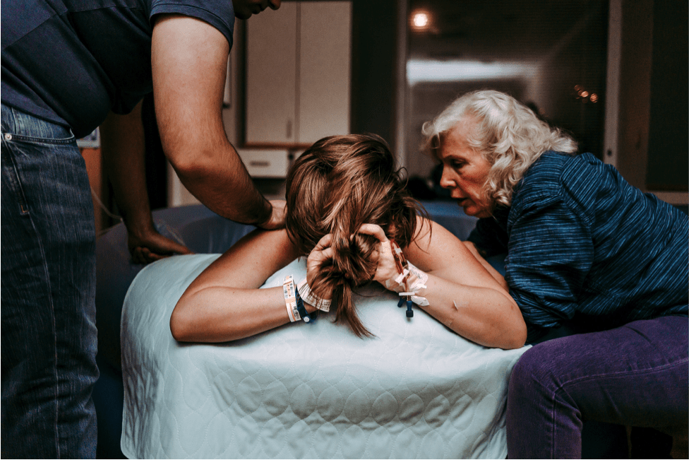 mother being supporting in birth pool