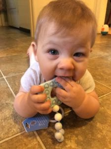 baby chewing on teether