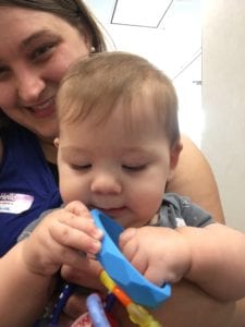 baby holding teething bracelet